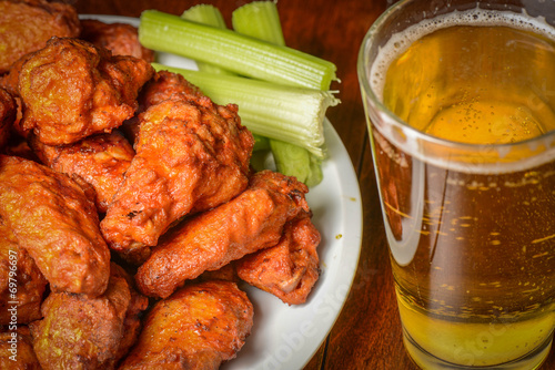 Buffalo Wings with Celery Sticks and Beer