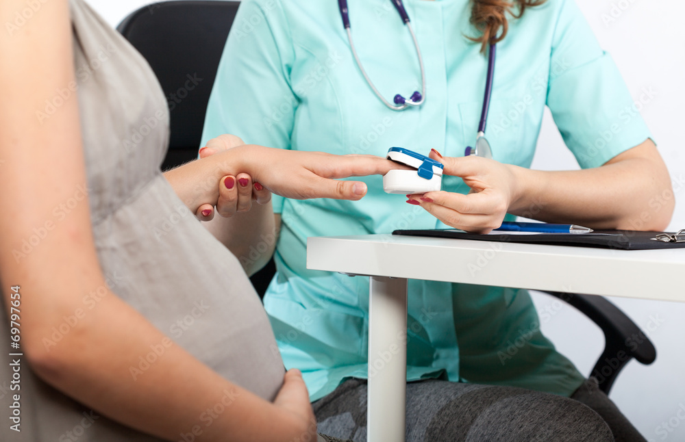 Pregnant woman during pulse measurement Pregnant woman during pulse measurement