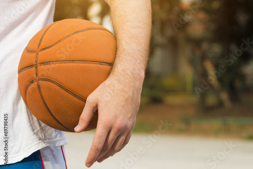 Basketball player on a outdoor court.