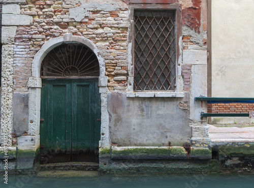 Detail of a door over a canal, Venice, Italy. © Asuriel77