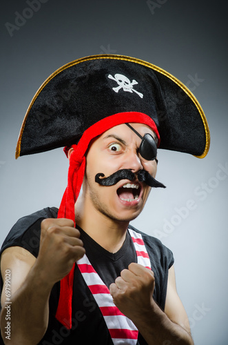 Funny pirate in the dark studio