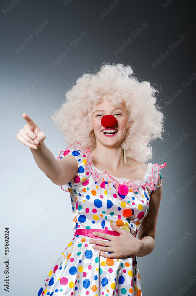 Clown with white wig against grey background Clown with white wig against grey background