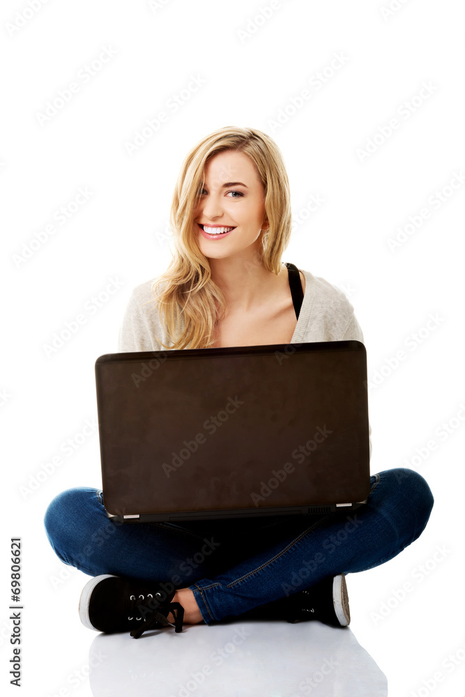 Smiling woman using a laptop Smiling woman using a laptop