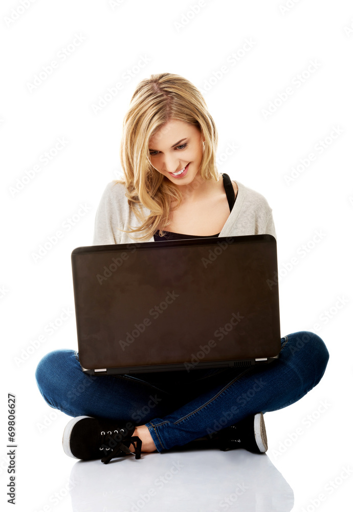 Smiling woman using a laptop Smiling woman using a laptop