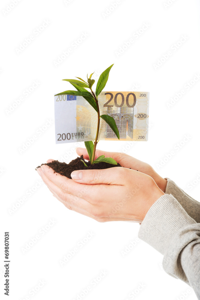 Woman with plant and dirt in hand