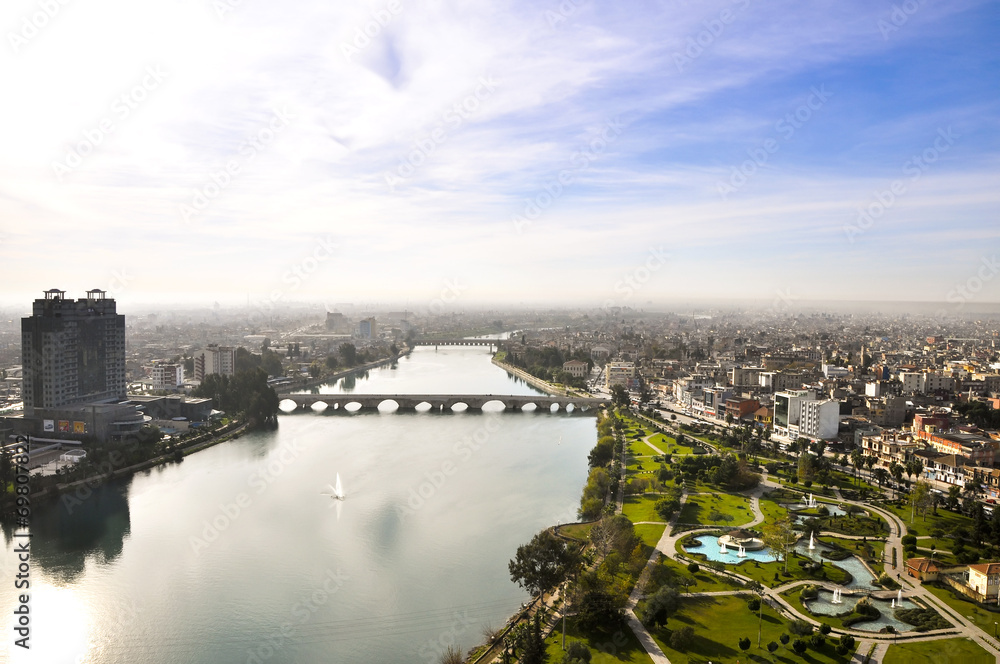 Fototapeta premium View of Adana and Seyhan river over the minaret of the mosque