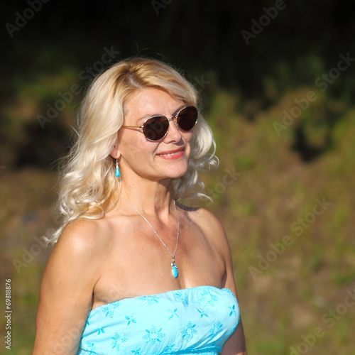 mature blonde in a vintage dress posing