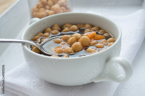 Fried batter pearls in soup with spoon