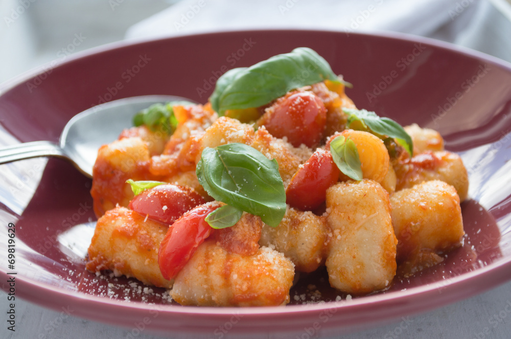 Gnocchi with tomato sauce and basil leaves Gnocchi with tomato sauce and basil leaves