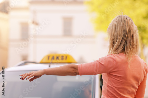 Photos woman raising her arm to call a taxi