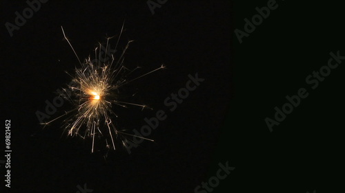 Fuse/sparkler burning on black background