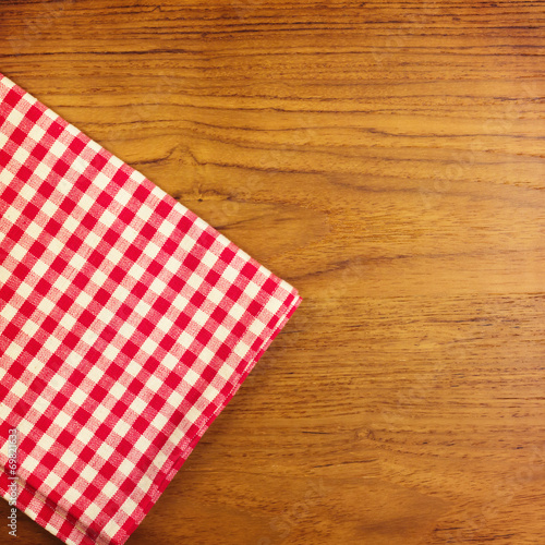Wooden table with red checked tablecloth