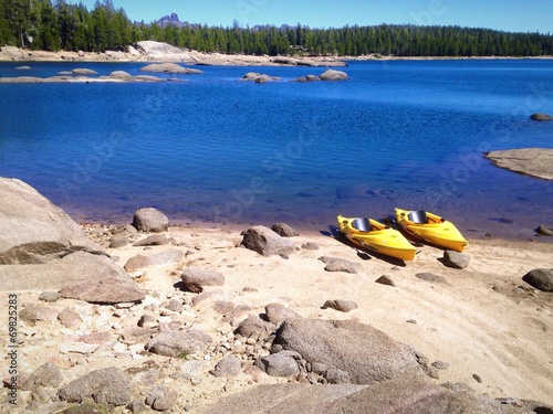 Two kayaks on the shore of a beautiful Mountain Lake.