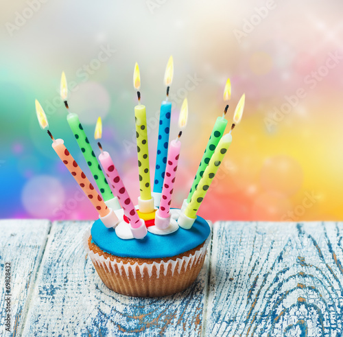 Birthday cupcake with burning candles