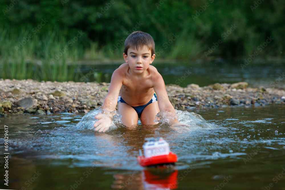 Boy playing in the river Boy playing in the river