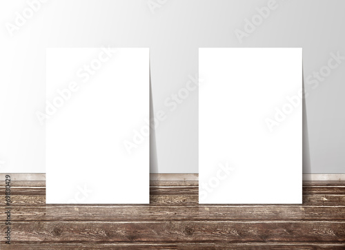 Two blank white paper template banners on the wooden floor again