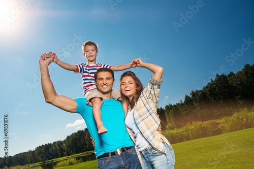 Happy young family with their child outdoors