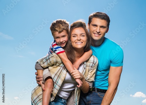 Happy young family with their child outdoors