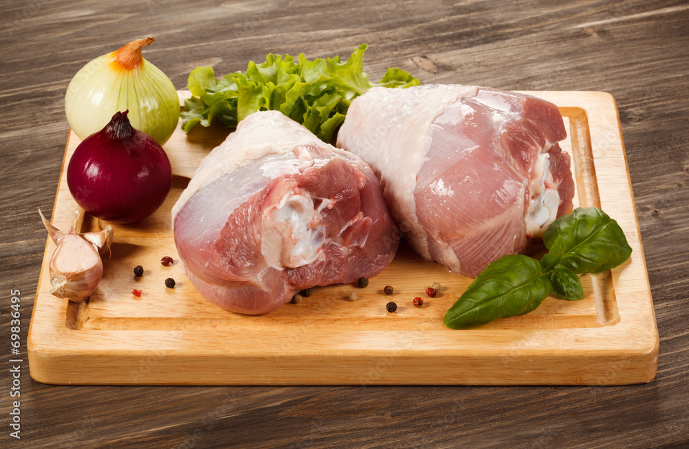Raw turkey legs on cutting board Raw turkey legs on cutting board