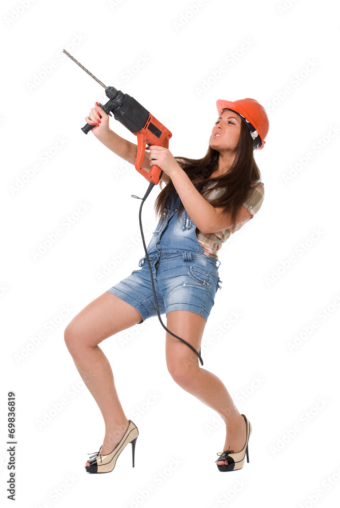 Young woman in jeans witch electric hammer drill.Isolated. Young woman in jeans witch electric hammer drill.Isolated.