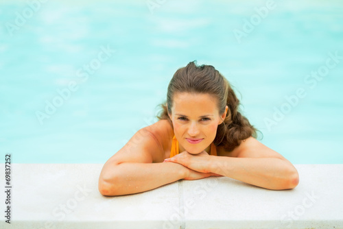 Portrait of relaxed young woman in swimming pool
