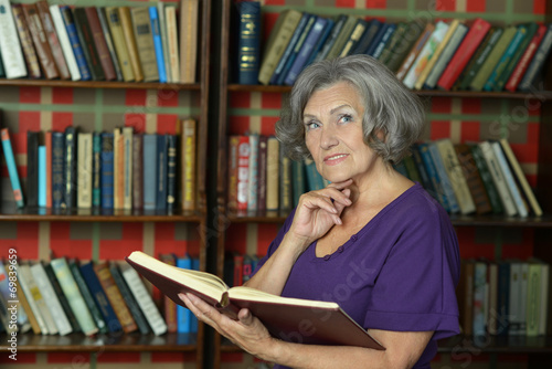 Beautiful elderly woman with book