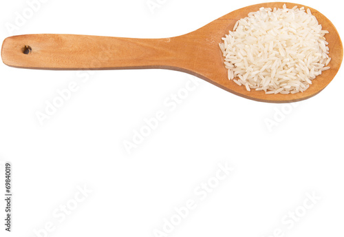 Raw and uncooked rice in wooden spoon over white background