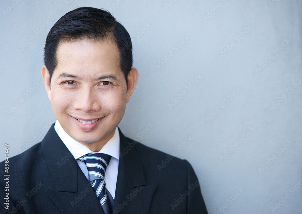 Smiling businessman on gray background Smiling businessman on gray background