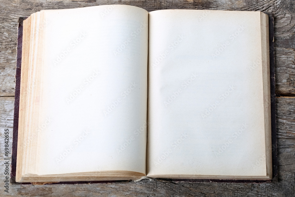 Naklejka premium Vintage book, open, on old wooden table