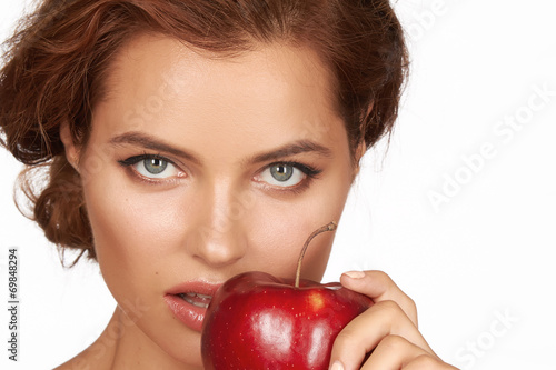 Sexy girl holding big red apple to enjoy the taste smile, teeth