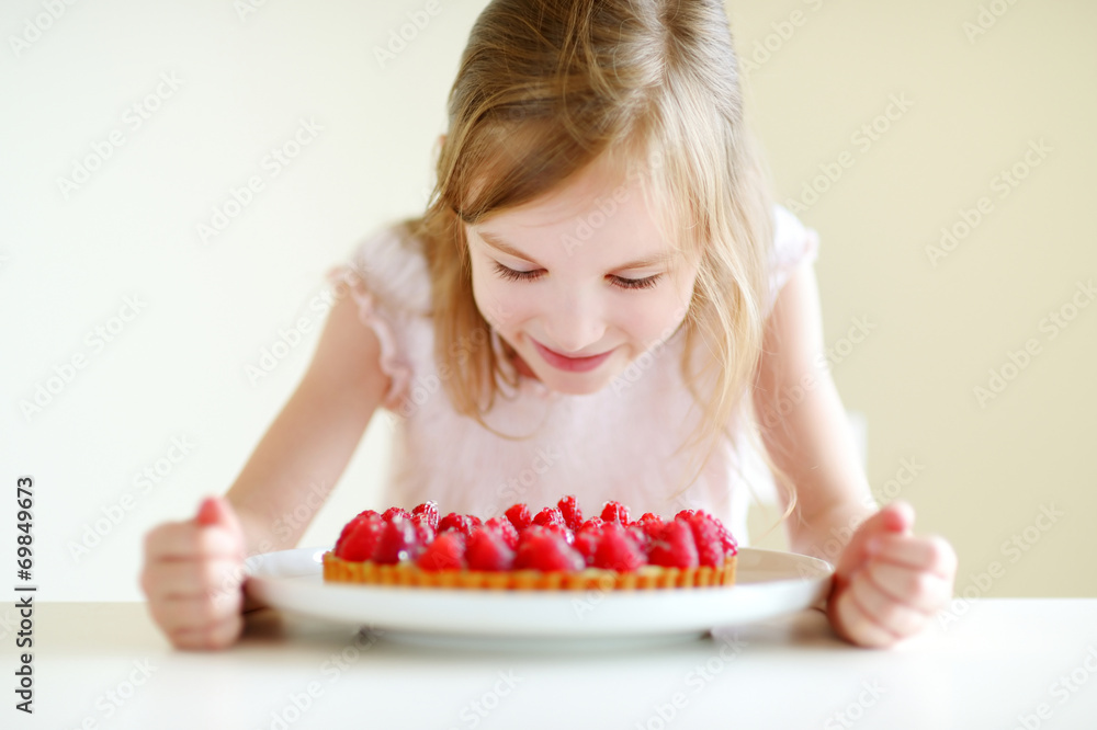 Adorable little girl and raspbrerry cake