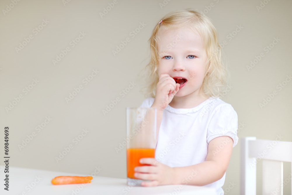 Adorable toddler girl eating carrots Adorable toddler girl eating carrots