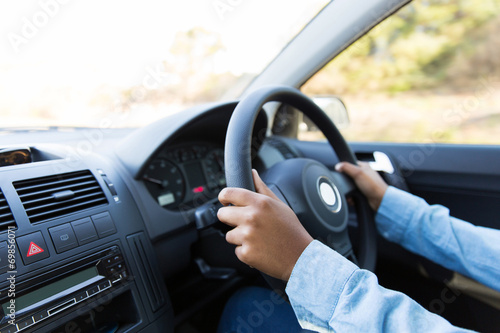 woman's hands holding steering wheel