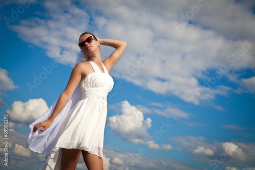 Beautiful Young Woman over blue Sky