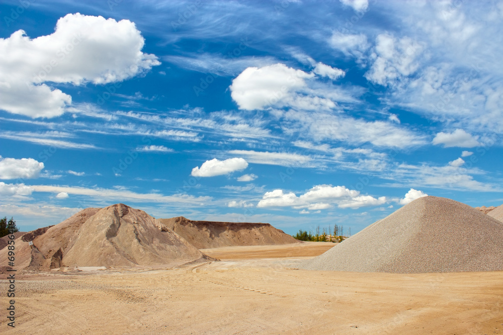 Sand and gravel quarry construction site with cloudy blue sky - obrazy, fototapety, plakaty 