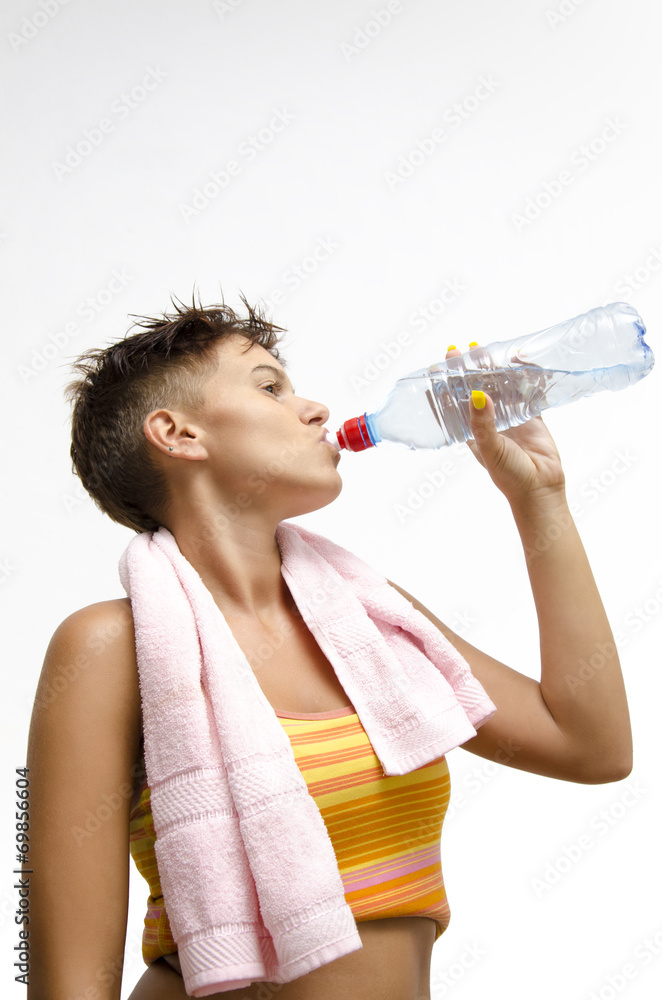 Girl drinking water from bottle after workout Girl drinking water from bottle after workout