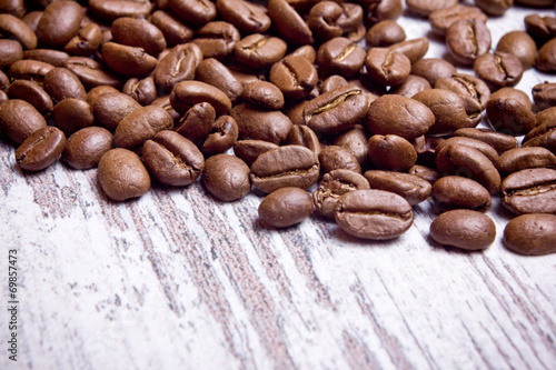 Coffee seeds on wooden surface texture. 