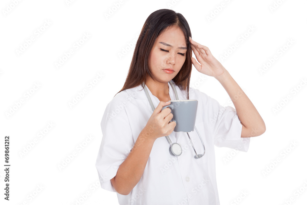 Asian young female doctor got headache with a cup of coffee Asian young female doctor got headache with a cup of coffee