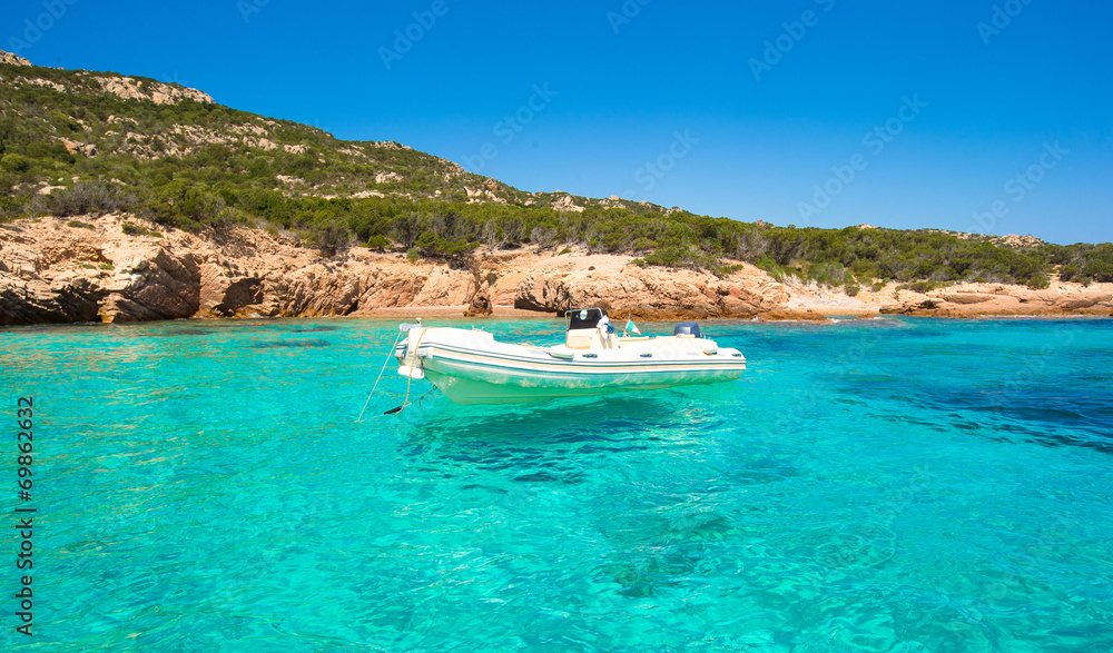 Small boat in turquoise clear sea
