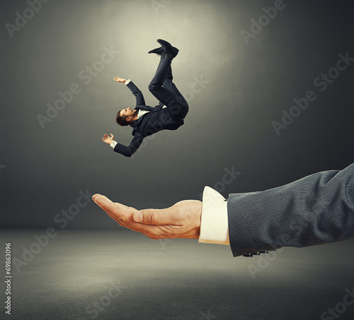 palm catching small startled businessman