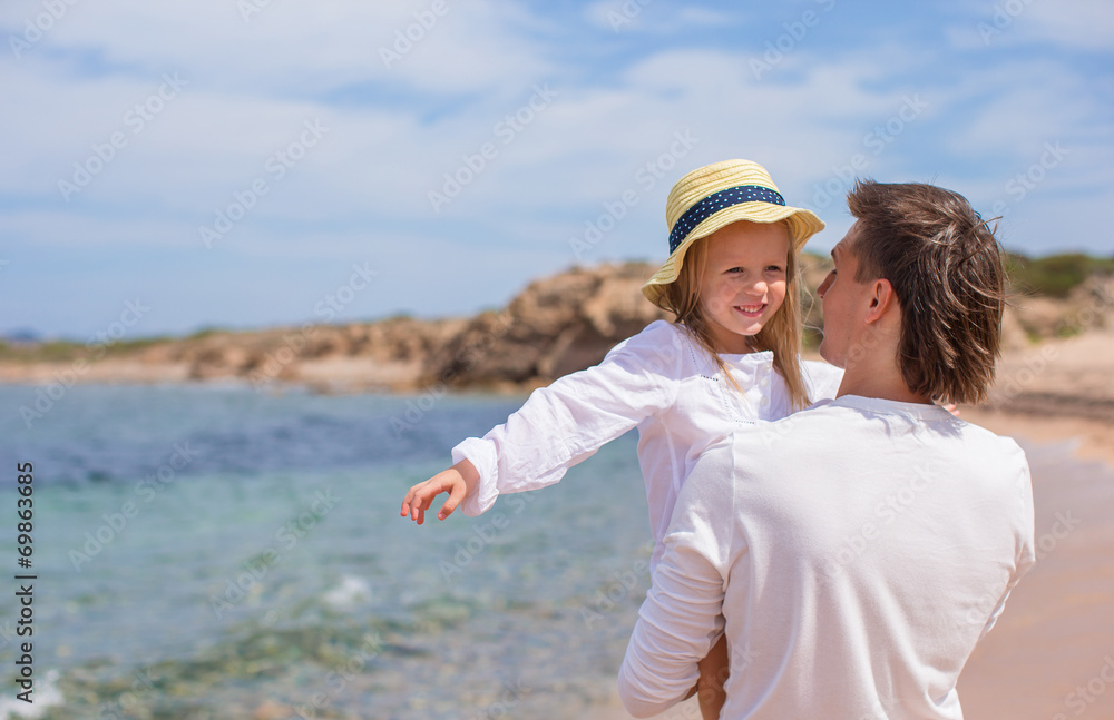 Happy father and cute little daughter have fun during beach