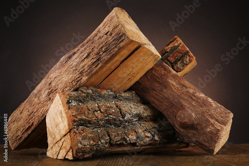 Fototapeta Heap of firewood on floor on dark background