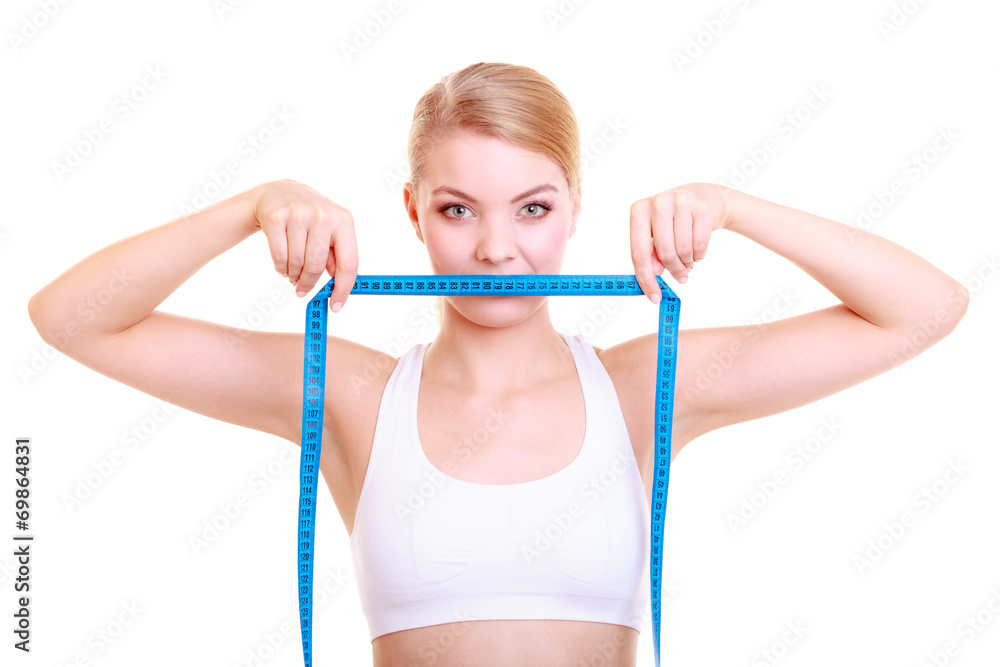 Fitness girl fit woman covering her mouth with measuring tape Fitness girl fit woman covering her mouth with measuring tape
