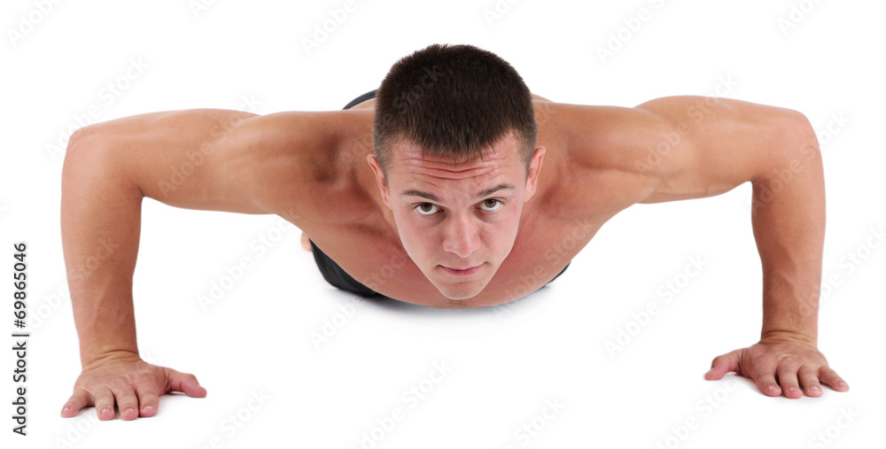 Handsome young muscular sportsman execute exercise isolated Handsome young muscular sportsman execute exercise isolated