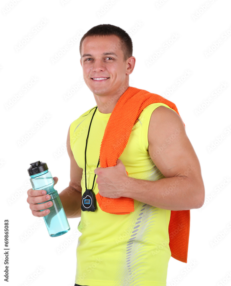Handsome young sportsman holding towel and bottle with water Handsome young sportsman holding towel and bottle with water