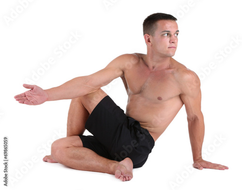 Handsome young muscular sportsman execute exercise isolated