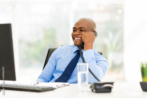 afro american businessman talking on landline phone photo