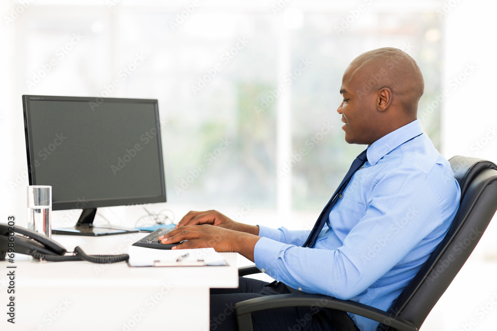 black business man typing on keyboard black business man typing on keyboard