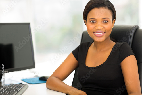 young african businesswoman relaxing in office