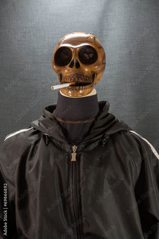 Human skull smoking a cigarette on a black background Human skull smoking a cigarette on a black background